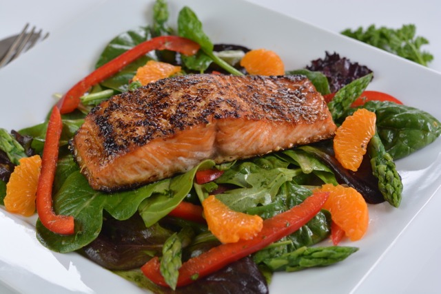 Sesame Salmon on Greens with red pepper, asparagus and orange segments.