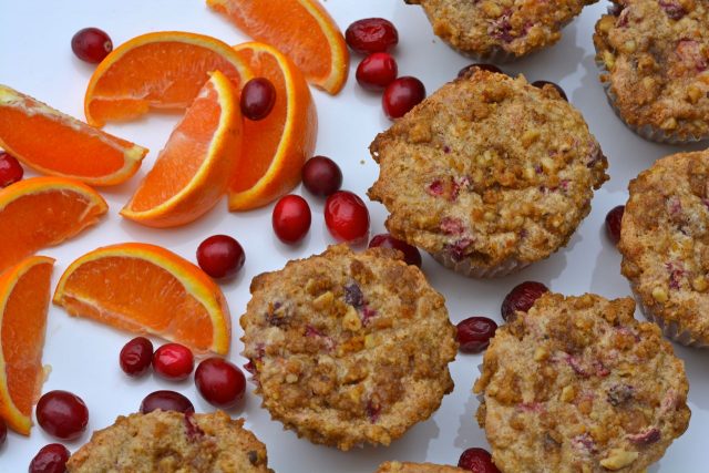 Cranberry Orange Muffins with orange wedges and cranberries.