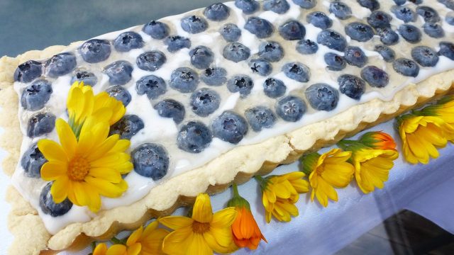 A gluten free flaky pie crust filled with vanilla cream and topped with blueberries.