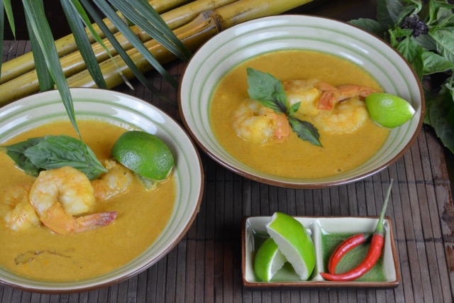 Two bowls of Thai Red Shrimp Curry with lime and chiles