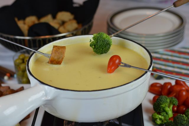 Gluten Free Swiss Cheese Fondue with forks loaded and ready to dip.