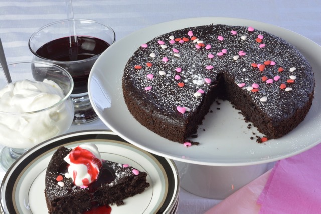 Quinoa Chocolate Cake with whipped cream and raspberry syrup