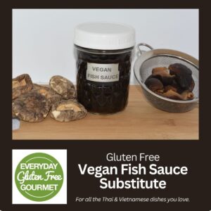 A jar of a Vegan Fish Sauce Substitute surrounded by dried and reconstituted shiitake mushrooms.