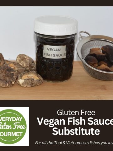 A jar of a Vegan Fish Sauce Substitute surrounded by dried and reconstituted shiitake mushrooms.
