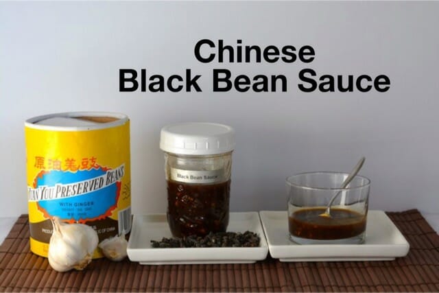 A jar of homemade gluten free Chinese Black Bean Sauce beside the original container of preserved beans.