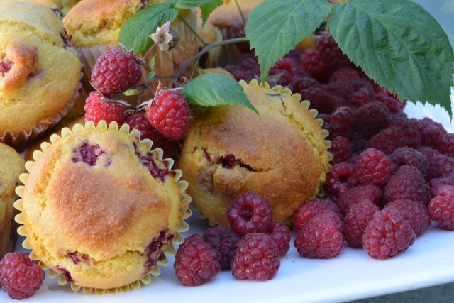 A tray of fresh Cornmeal Raspberry Muffins right out of the oven.