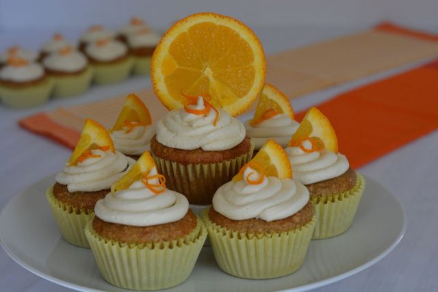 A pedestal tray filled with gluten free Orange Cupcakes.