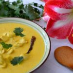 A bowl of Thai Yellow Chicken Curry made with gluten free coconut milk; garnished with fresh cilantro.