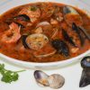 A bowl of Italian Fish and Shellfish Soup with mussels and clams.