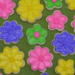 Flower shaped sugar cookies decorated with colourful royal icing