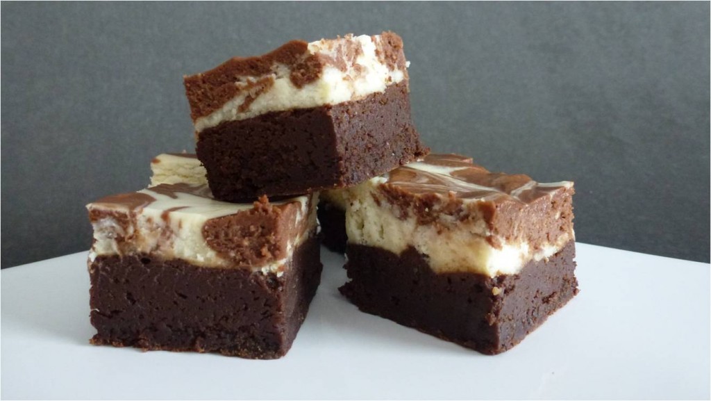 A close up of three squares of delicious gluten free chocolate cheesecake brownies