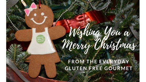 A gingerbread lady wearing an Everyday Gluten Free Gourmet apron, hanging on a Christmas tree