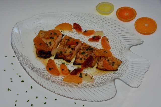 Cooked Arctic Char with Citrus Sauce and chives.