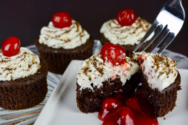 A fork digging into Black Forest Cupcakes.