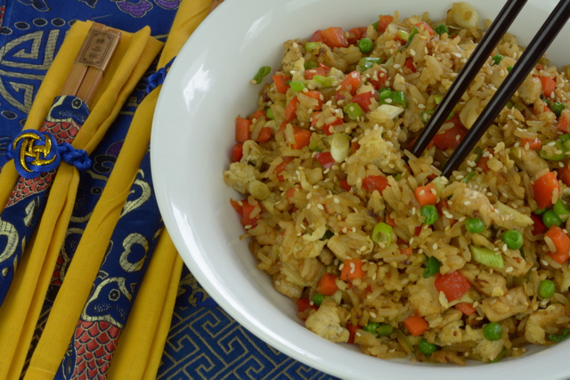 A bowl of Chicken Fried Rice with chopsticks.