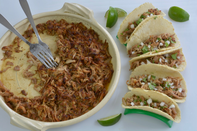 Mexican Pork Carnitas served with chopped white onion and cilantro