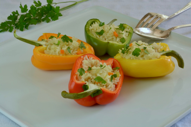 Four half peppers stuffed; red, yellow, green and orange. Each with the same rice filling.