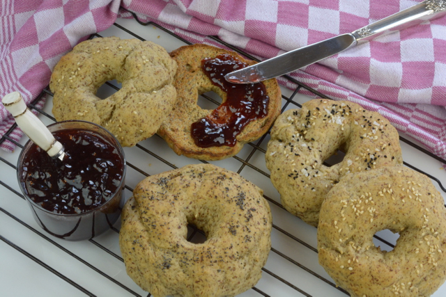 Vegan Bagels just out of the oven served with strawberry jam.