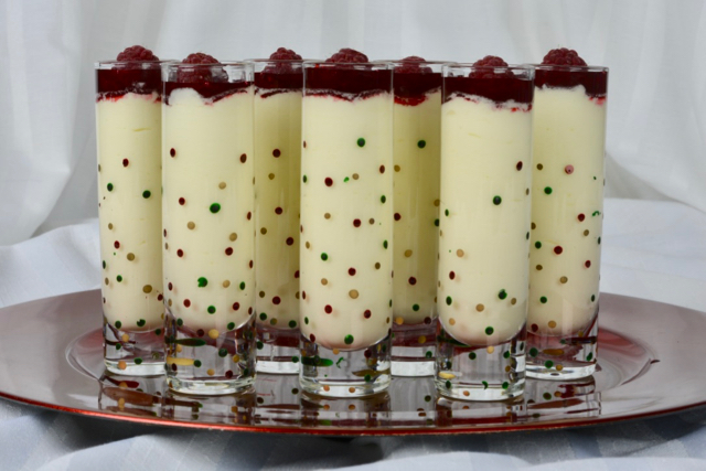 White Chocolate Mousse shots with raspberry sauce and a raspberry