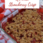 A square pan of Rhubarb Strawberry Crisp surrounded by a red and white tea towel with a Canadian maple leaf pattern.