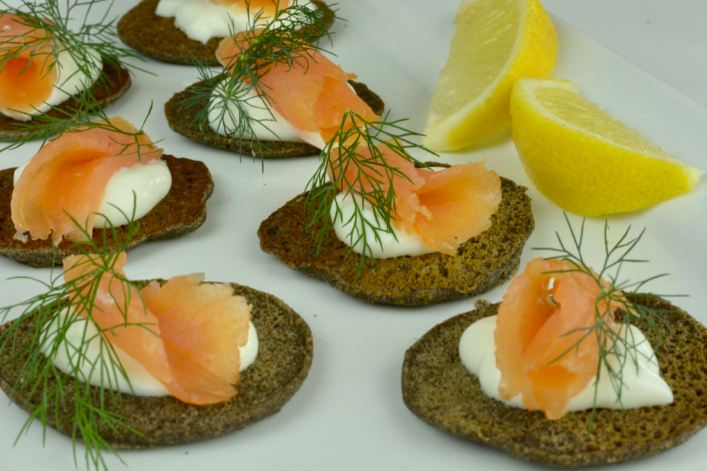 Mini buckwheat Blinis with smoked salmon, sour cream and dill are nice as a Holiday Appetizer.