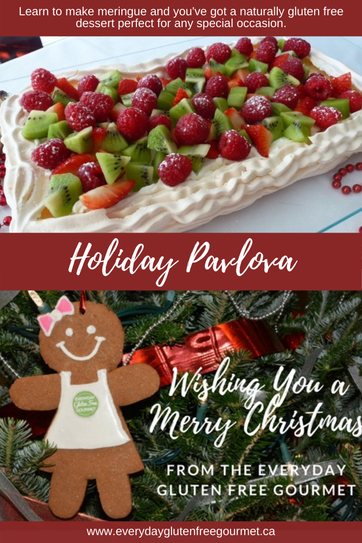 Holiday Pavlova glistening with red and green fruit for a stunning presentation.