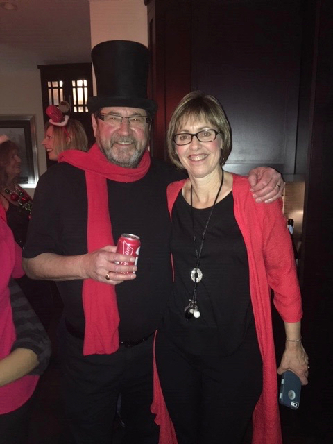 Jim and Cinde in black and red for a festive December birthday celebration, part of a recipe for happiness.