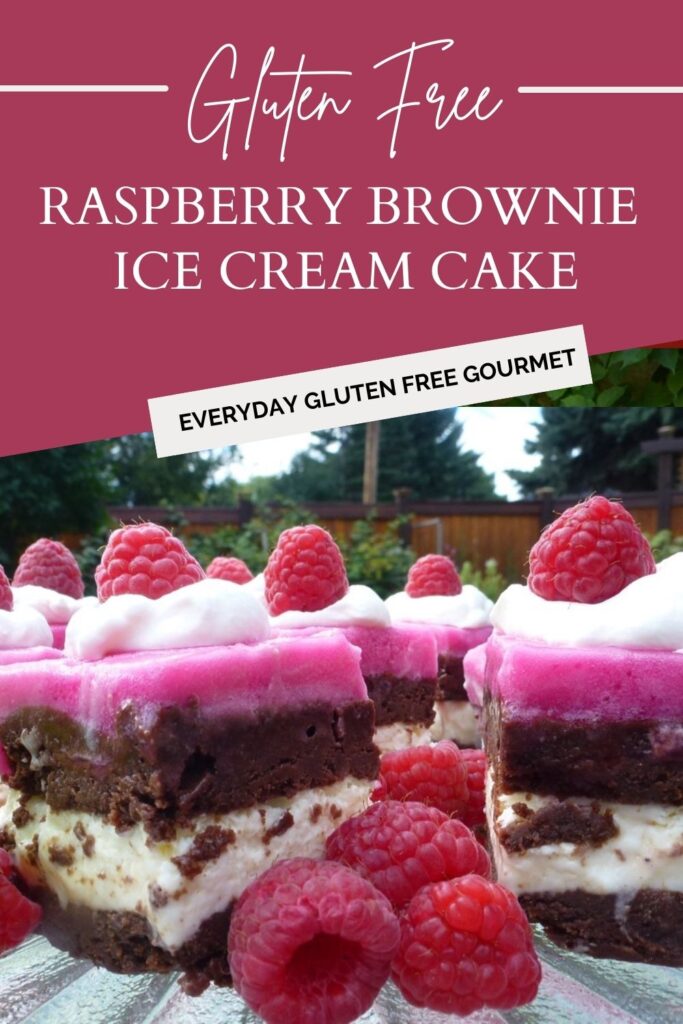 A tray with squares of gluten free Raspberry Brownie Ice Cream Cake topped with whipped cream and fresh raspberries.