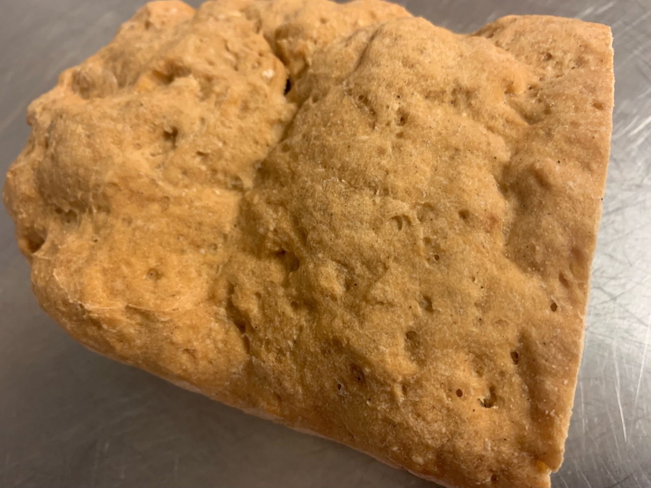 Top down view of a loaf of gluten free crusty bread.