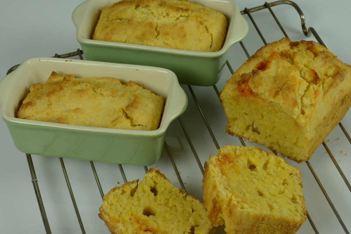 Mini cornbread loaves on a wire rack.