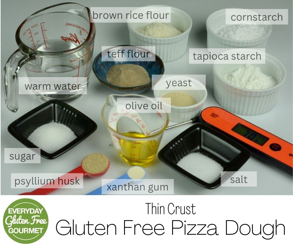 Cups, bowls and measuring spoons with all the ingredients to make this thin crust gluten free pizza dough.