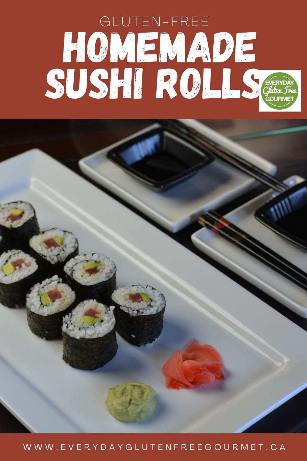 A white tray with homemade sushi rolls, soy sauce, pickled ginger and wasabi paste.