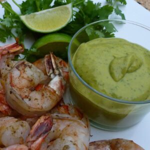 A dish of Avocado Chipotle Sauce with grilled shrimp.