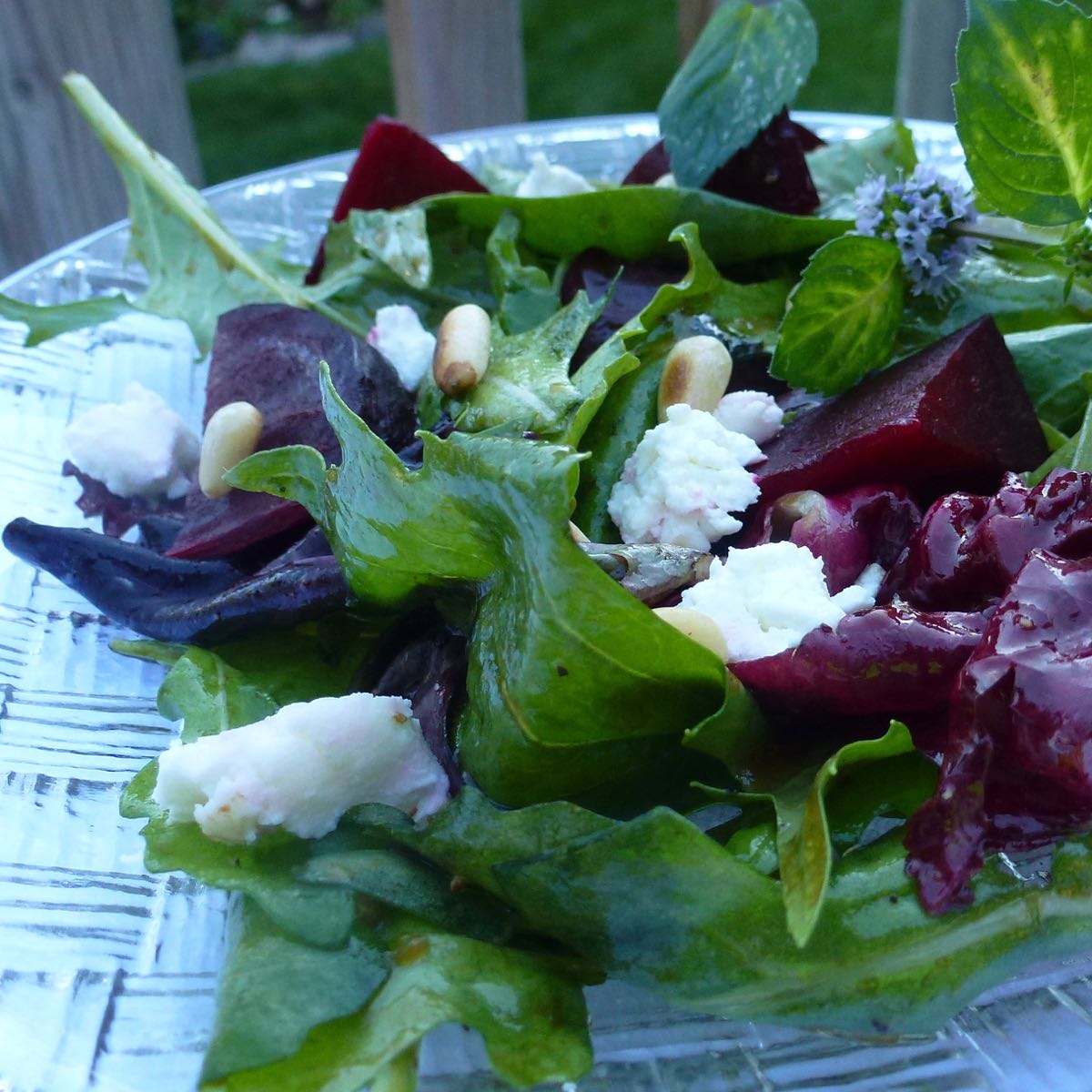 A plate of Salad with Beets, Goat Cheese and Pine Nuts.