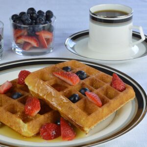 Gluten Free Waffles with strawberries, blueberries and maple syrup.