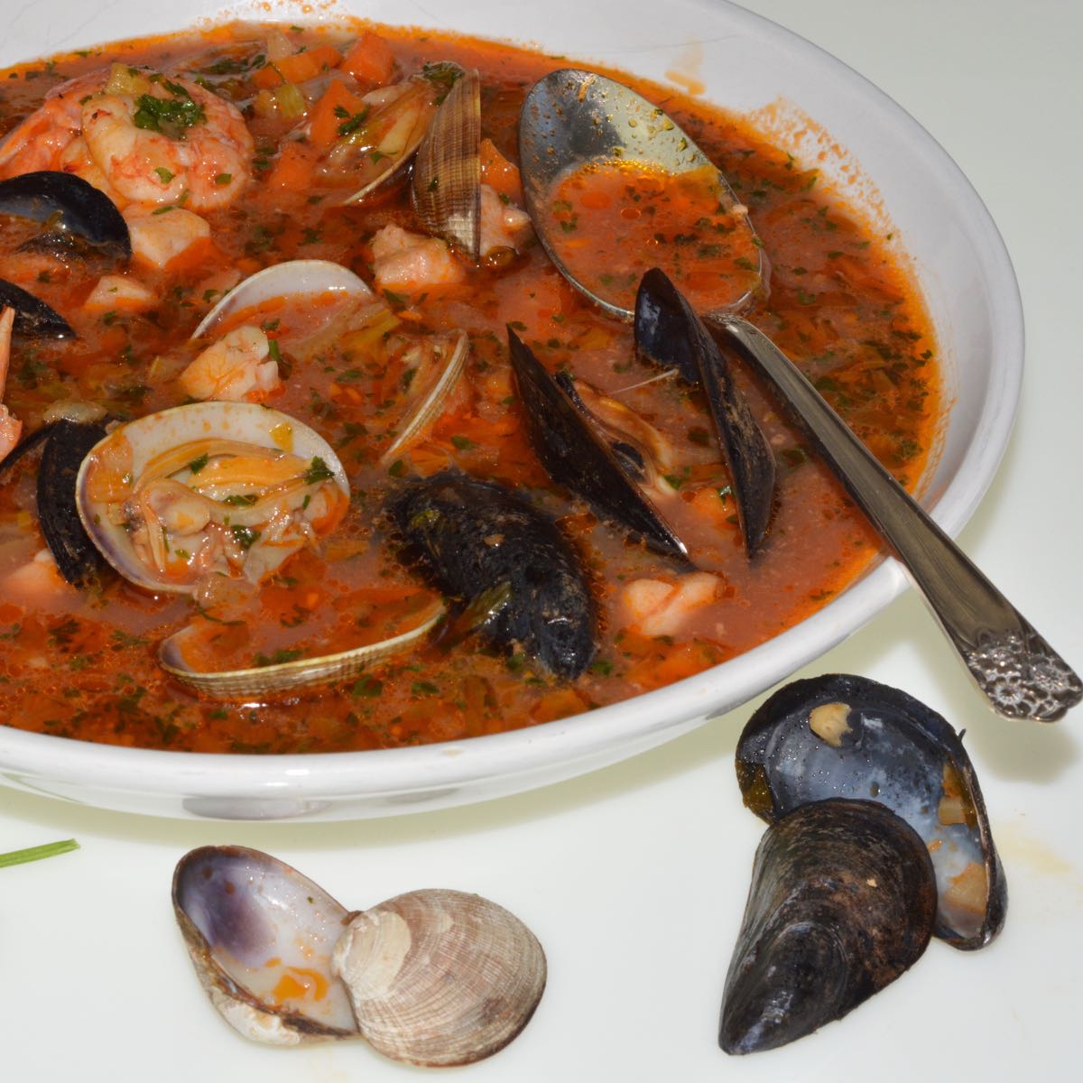 A bowl of Italian Fish and Shellfish Soup with mussels and clams.