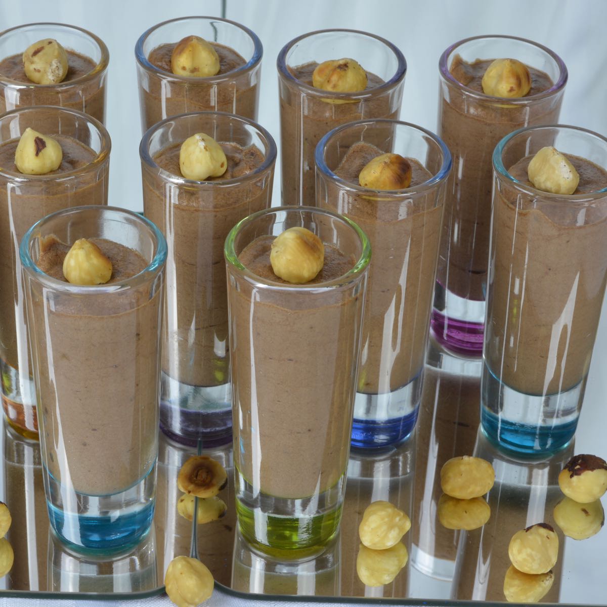 Ten Nutella Mousse shots each topped with a toasted hazelnut.