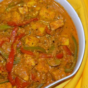 Gluten Free Paneer and Peppers in Fragrant Gravy in a serving dish.