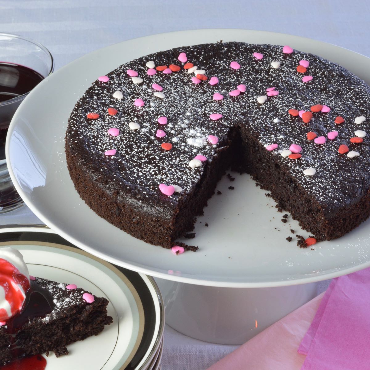 Quinoa Chocolate Cake with whipped cream and raspberry syrup.