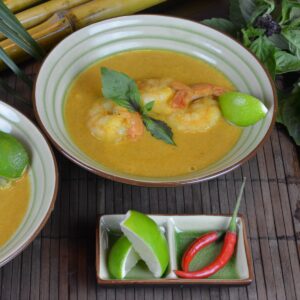 Two bowls of Thai Red Shrimp Curry with lime and chiles