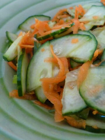 Thai salad of thinly sliced cucumber and grated carrot.