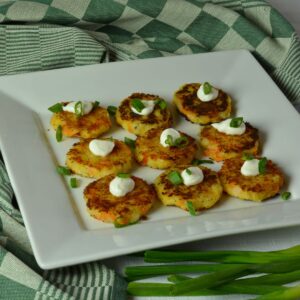 A platter of Bubble and Squeak Patties topped with sour cream and chives.