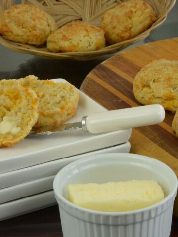 Gluten free Cheese Biscuits on a board served with extra butter.