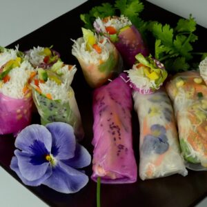 A black platter with Vietnamese Salad Rolls with a variety of fillings.