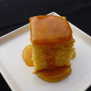 A plate of gluten free cornbread covered in corn syrup