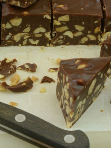 Eatmore bars on a cutting board being cut into thick diamond shapes.