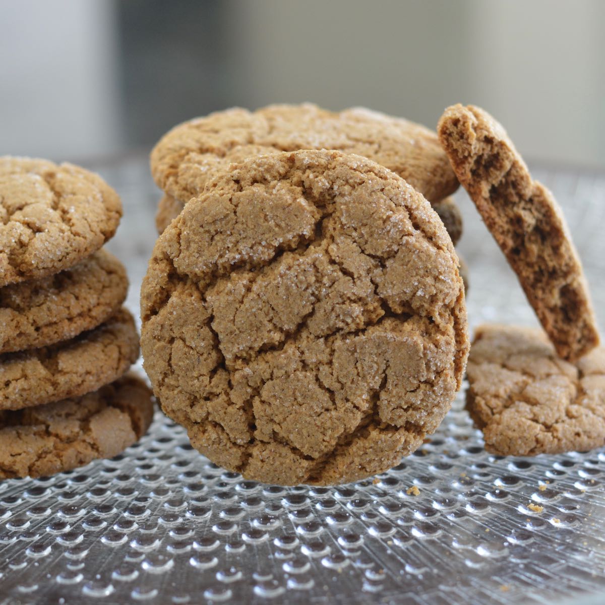 A stack of Molasses Ginger Cookies on a clear plate.