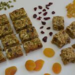 Gluten Free Granola bars surrounded by dried fruit and nuts..