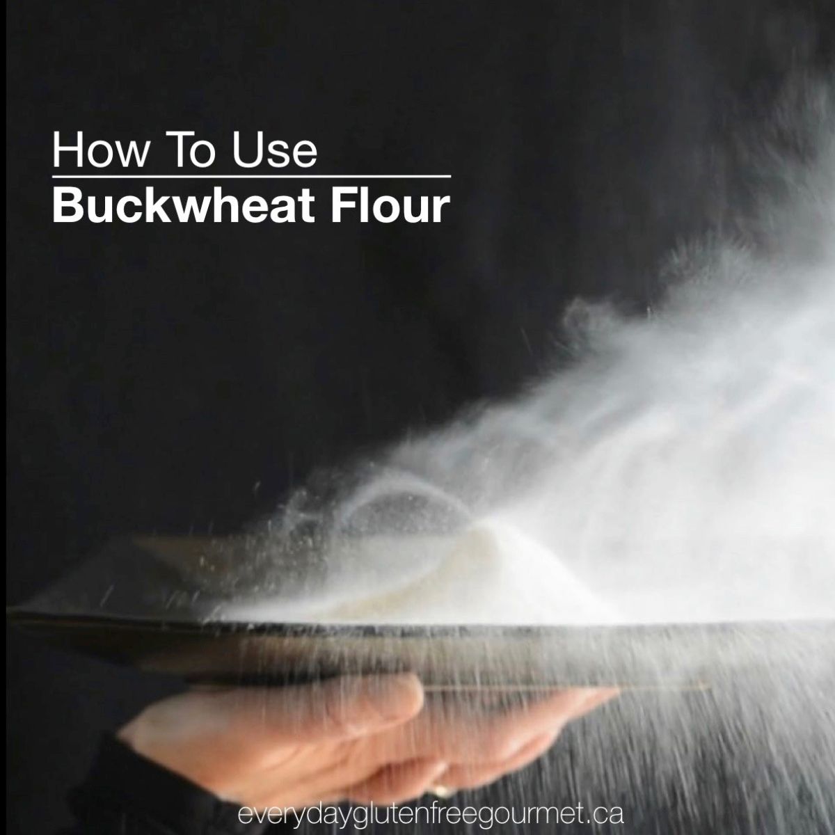 A black background showing two hands holding a black plate with a pile of buckwheat flour and a cloud of it being blown off the plate.