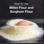An egg just dropped into a pile of millet flour.